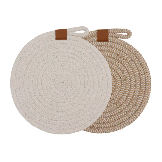 Nash White Set of 2 Trivets. Two round woven trivets with brown straps on a white background