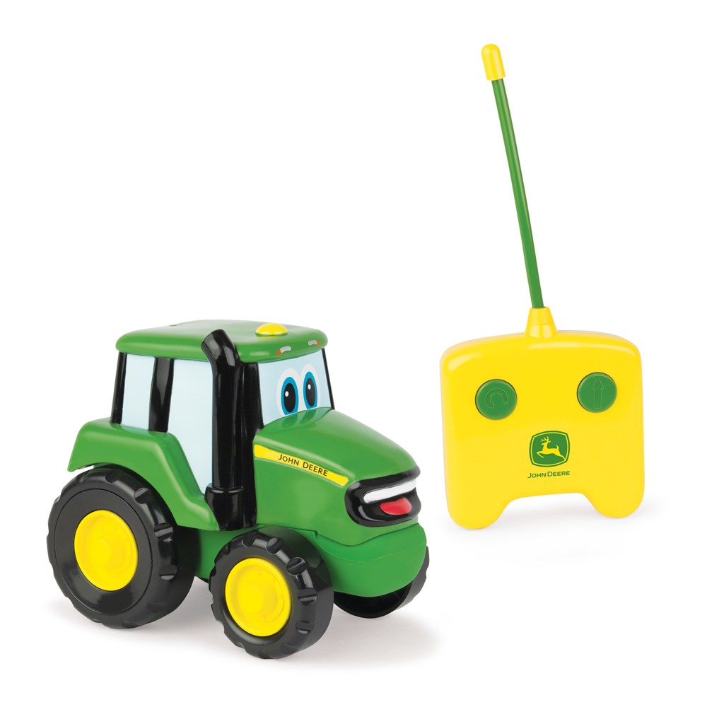 Toy tractor with a remote control on a white background