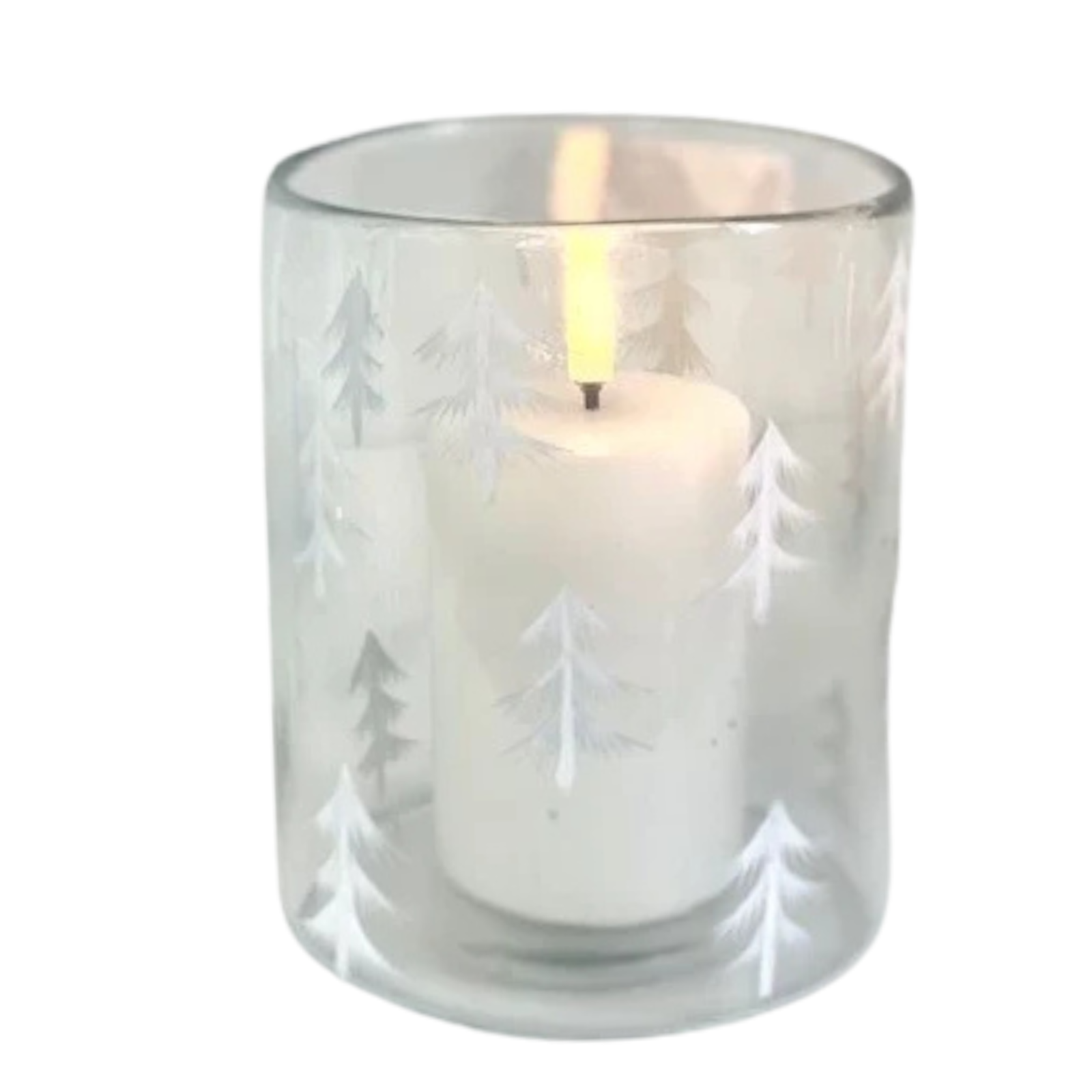 A white pillar candle lit inside a clear glass holder decorated with white etched pine tree silhouettes, shown against a plain white background.