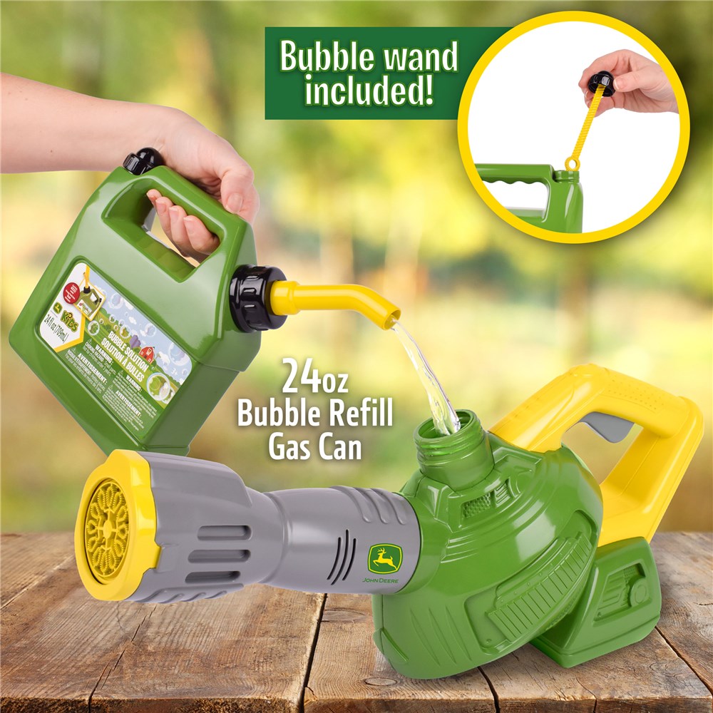 John Deere Bubble 'N' Fun Leaf Blower Combo with 709ml Bubble Refill Jerry Can. Green bubble refill gas can with yellow and gray accents, being refilled with a green container on a wooden surface.