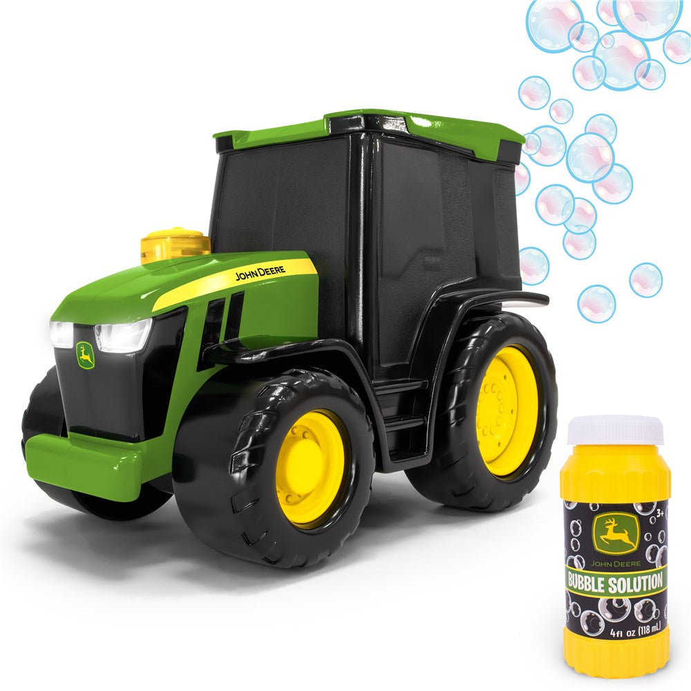 Toy tractor with black dump bed and bubble solution bottle on a white background