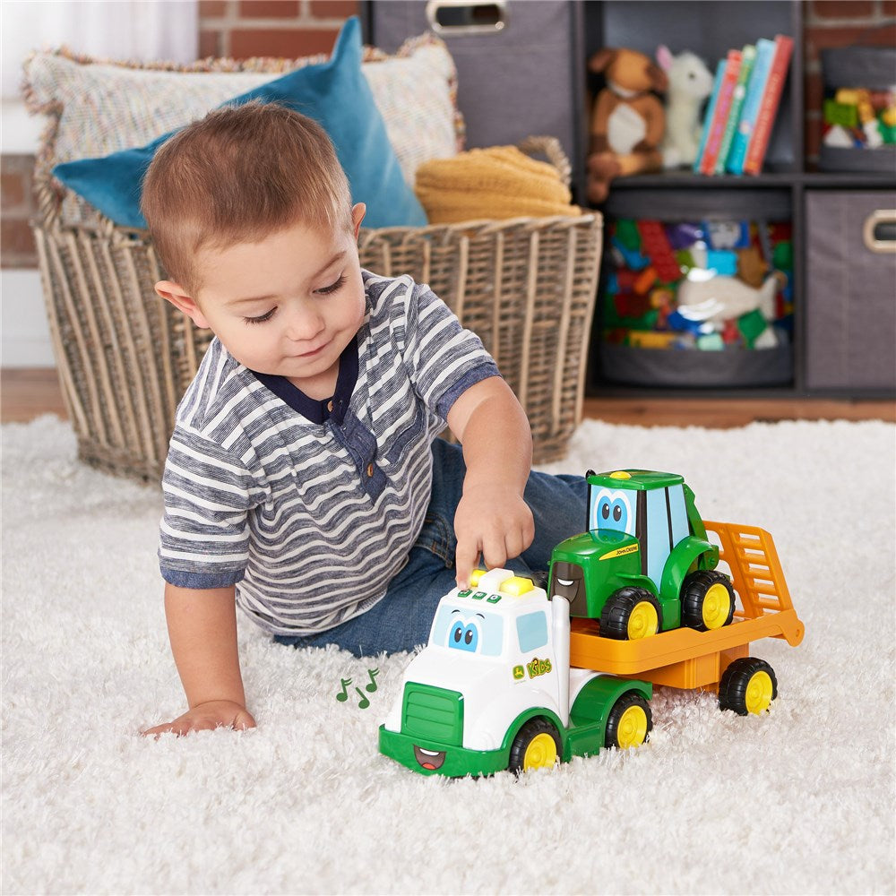 Child playing with toy trucks on a carpeted floor