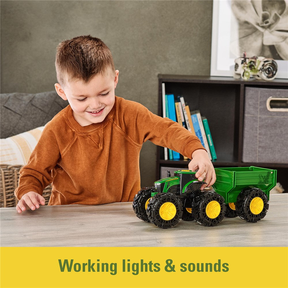 Child playing with a toy truck on a table, with books and decor in the background.