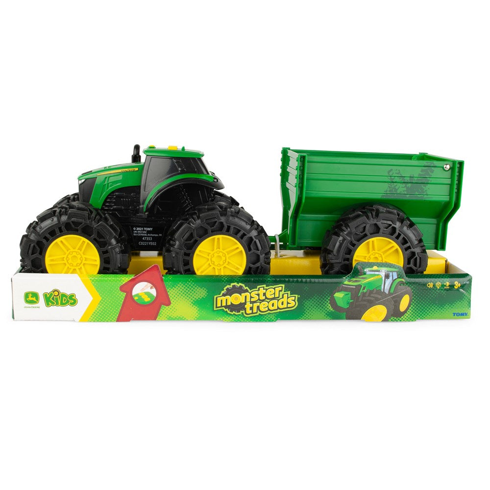 Toy tractor with trailer on a white background