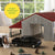 John Deere 1:32 Weathered Barn Play Set. Model farm with barn, truck, and horses in a display setting.