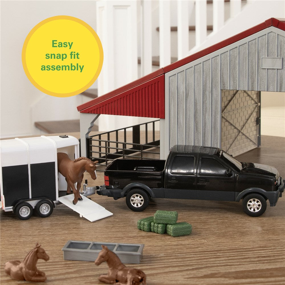John Deere 1:32 Weathered Barn Play Set. Toy truck with trailer and horses near a barn in a playset.