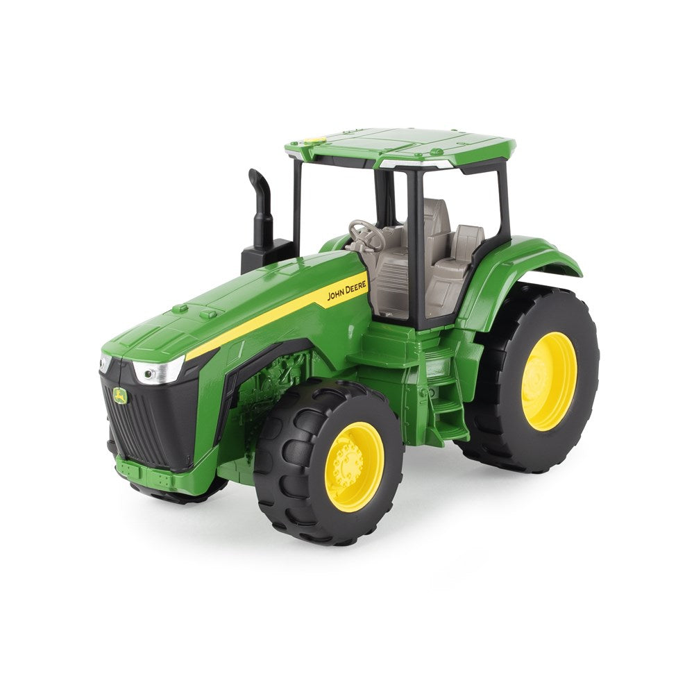 Toy tractor with green and yellow colors on a white background
