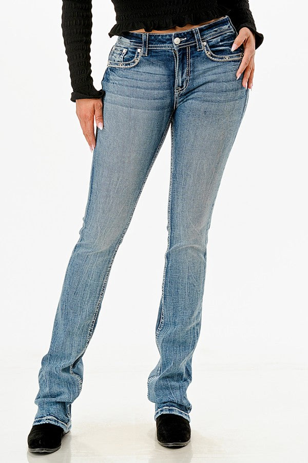 Grace in LA jean is a women's mid-rise, bootcut style with distinctive geo print embroidery on the back pockets.