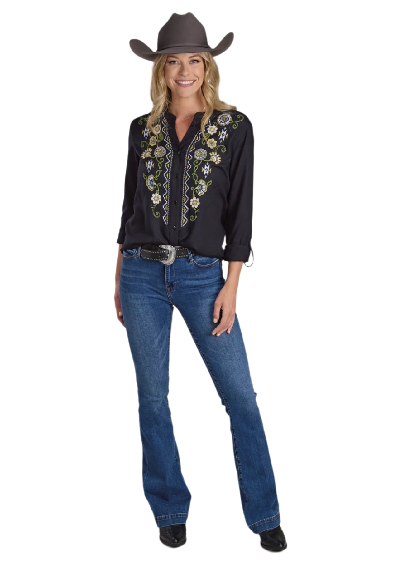 Roper Women's Studio West L/S Blouse. Woman in black embroidered shirt and blue jeans with a cowboy hat on a plain background.