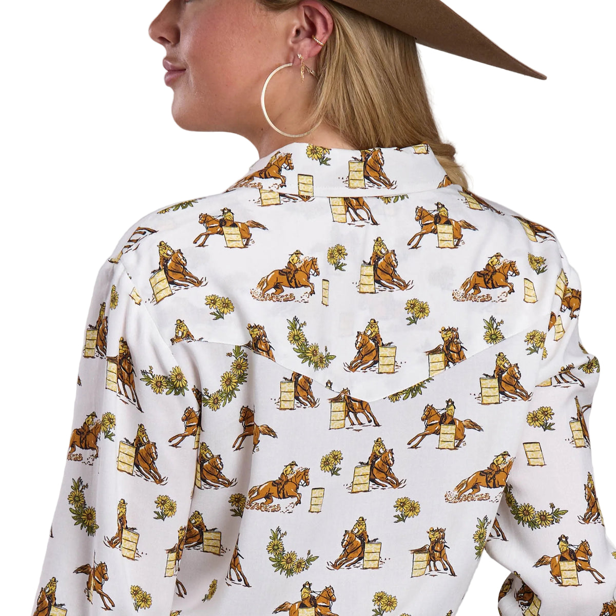 Person wearing a shirt with horse and rider pattern on a plain background