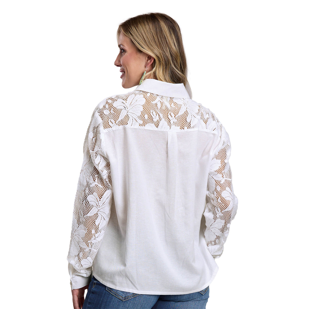 Woman wearing a white blouse with lace detailing on a white background