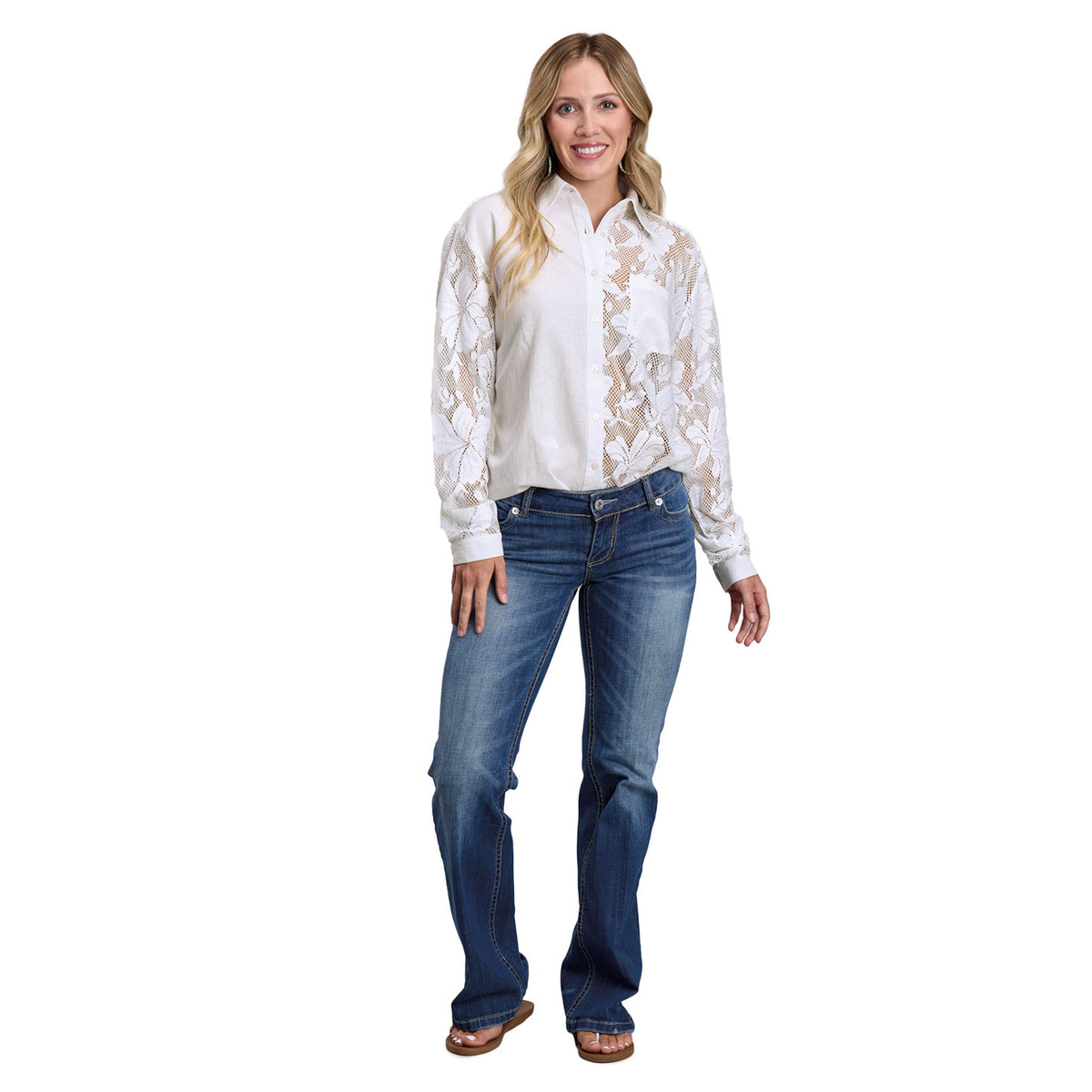 Woman wearing a white lace blouse and blue jeans on a white background