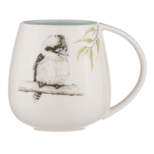 Ashdene Bush Buddies Kookaburra Snuggle Mug. A ceramic mug with a illustration of a Kookaburra bird perched on a branch, with a green accent on the inside of the mug and handle.