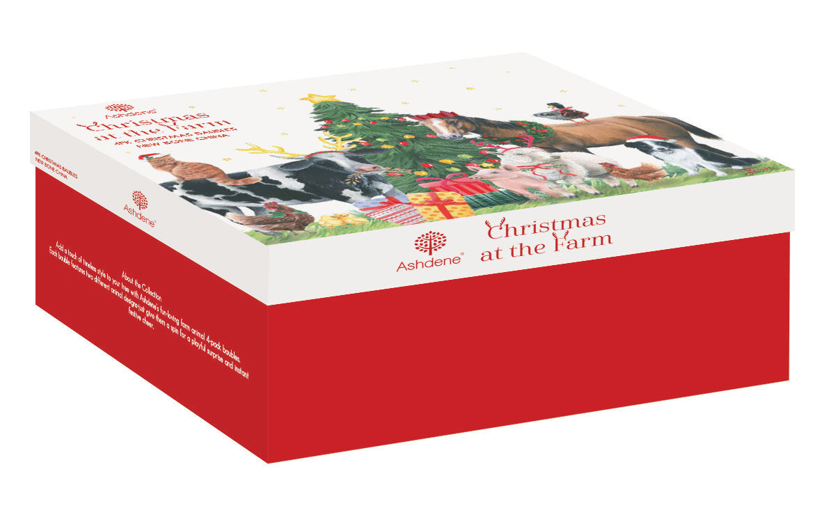 A boxed product package titled "Christmas at the Farm" by Ashdene, shown at an angle on a white background. The box is primarily red on the lower half with a white top panel featuring a holiday illustration of cows, a Christmas tree, and gifts.