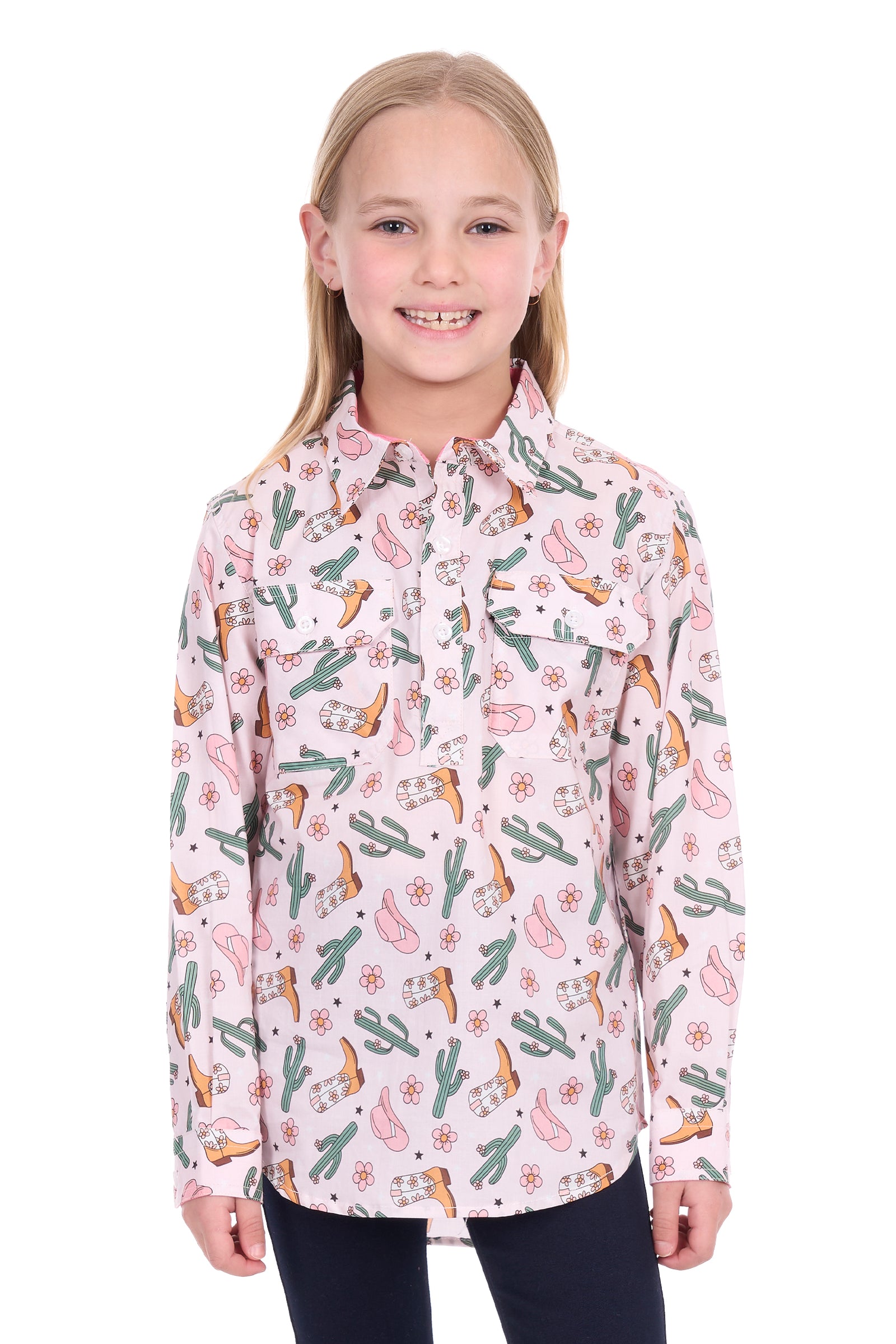 Young girl wearing a pink patterned shirt with cacti and boots on a white background
