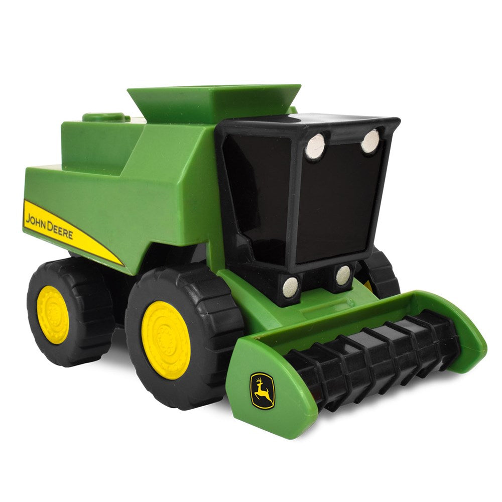 Toy combine harvester with John Deere branding on a white background