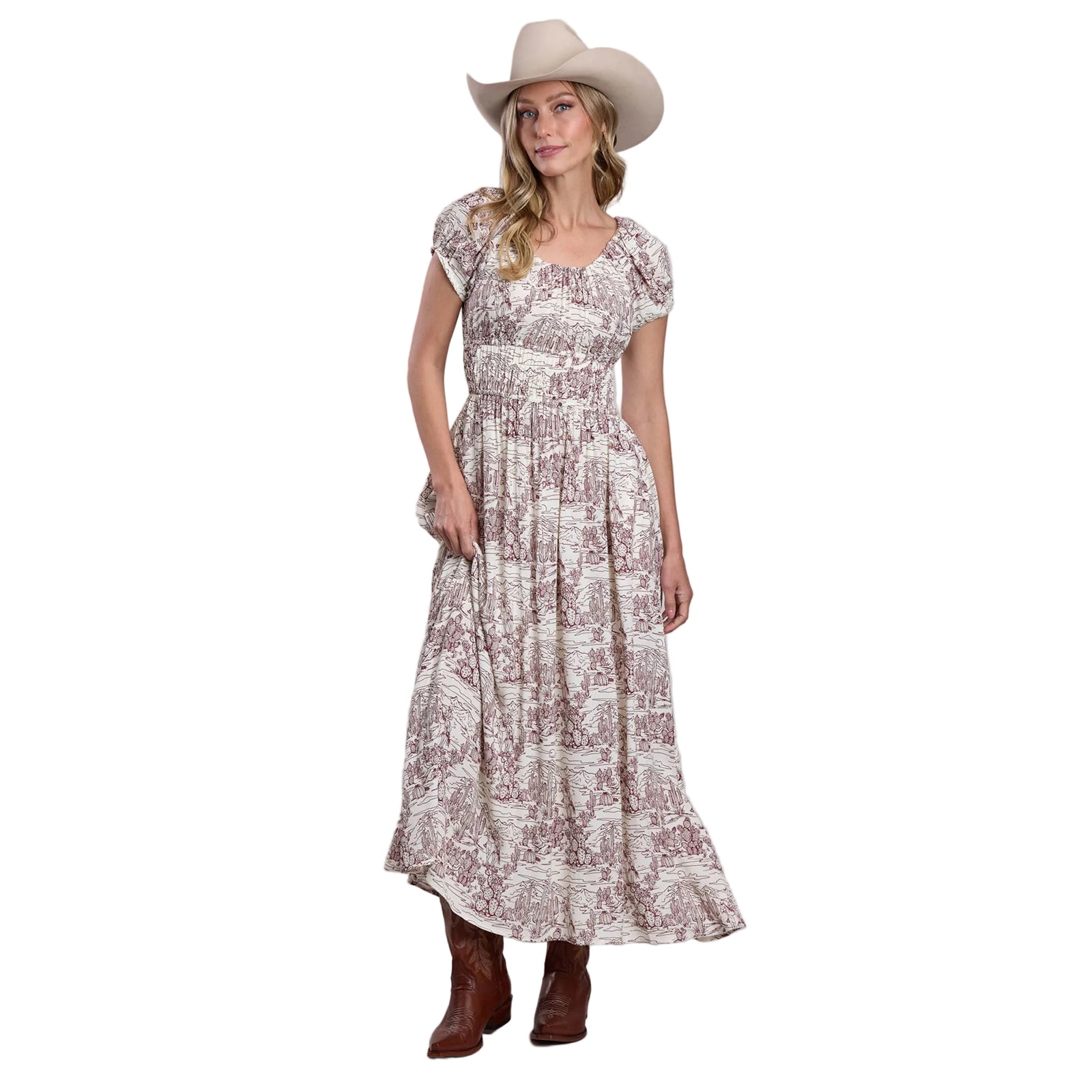 Woman wearing a patterned dress and cowboy hat on a plain background