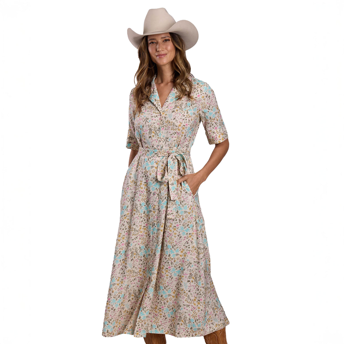 Woman wearing a floral dress and cowboy hat on a white background