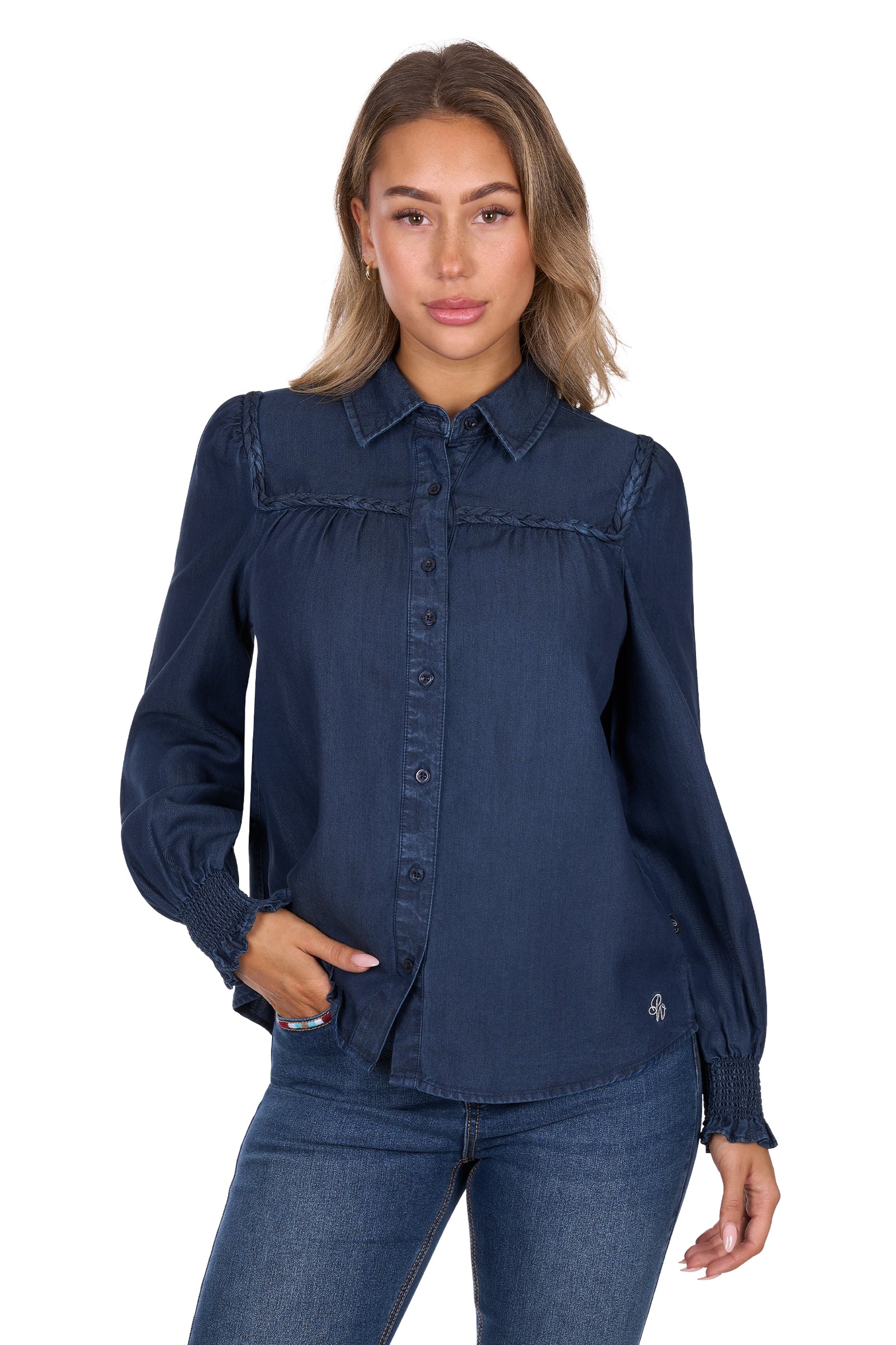 Woman wearing a navy blue denim shirt and jeans on a white background