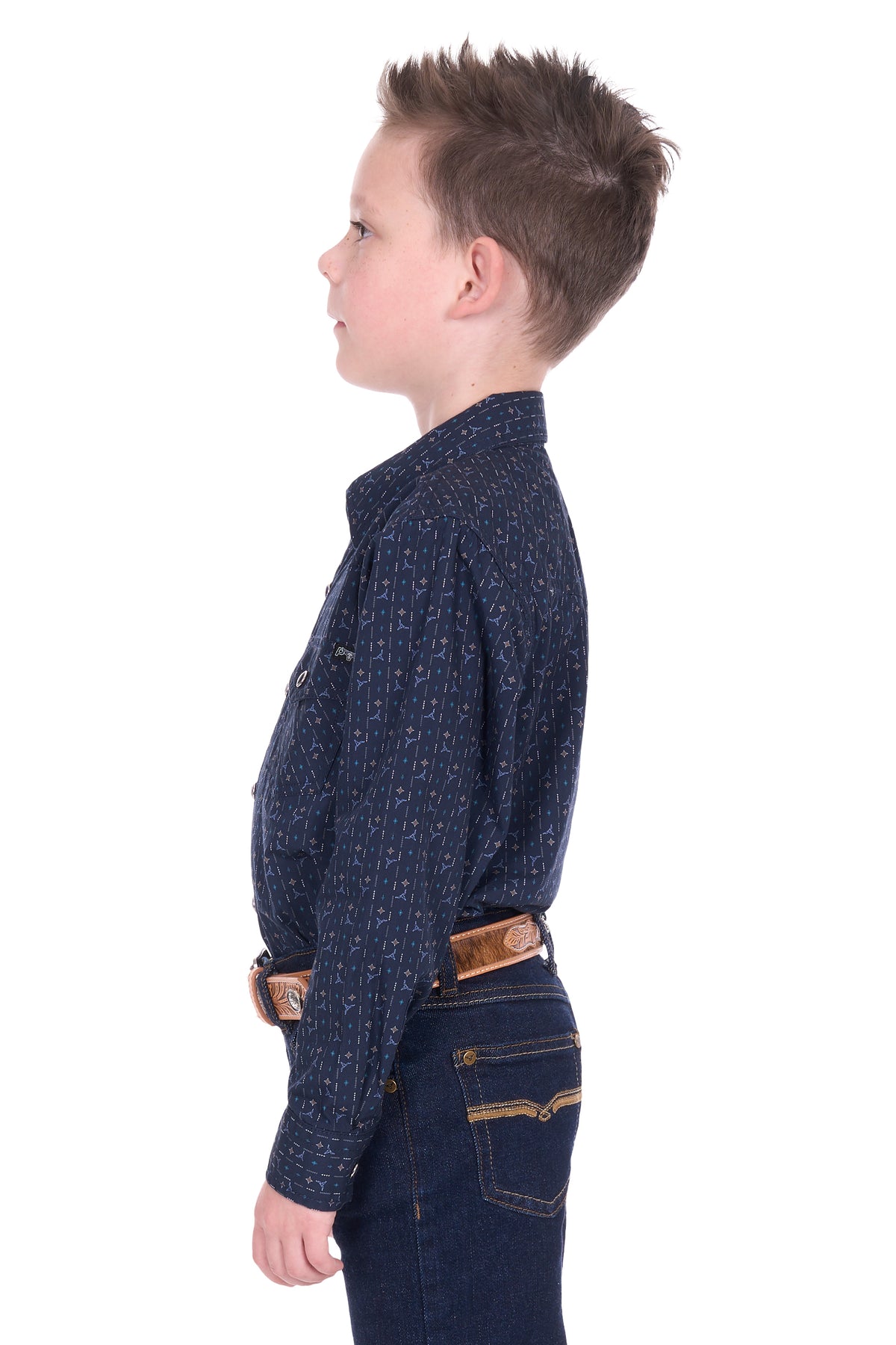 Child wearing a dark blue patterned shirt and jeans on a white background