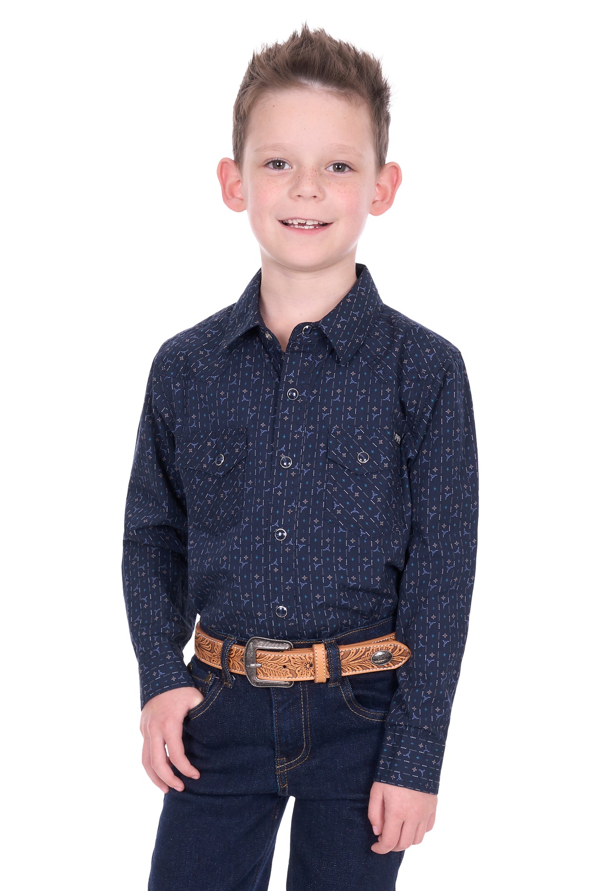 Young boy wearing a dark blue patterned shirt and jeans on a white background