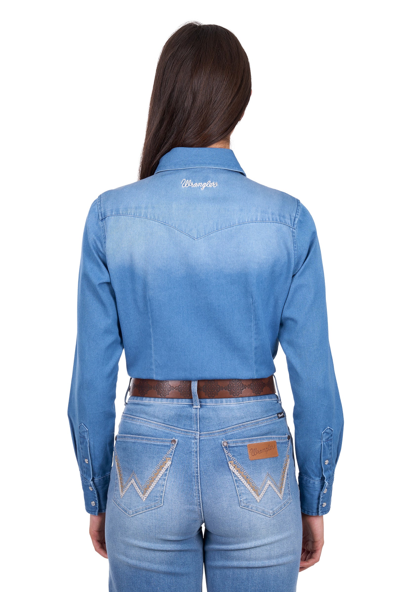 Woman wearing a blue denim shirt with 'Morgan' branding on the back, standing against a white background.