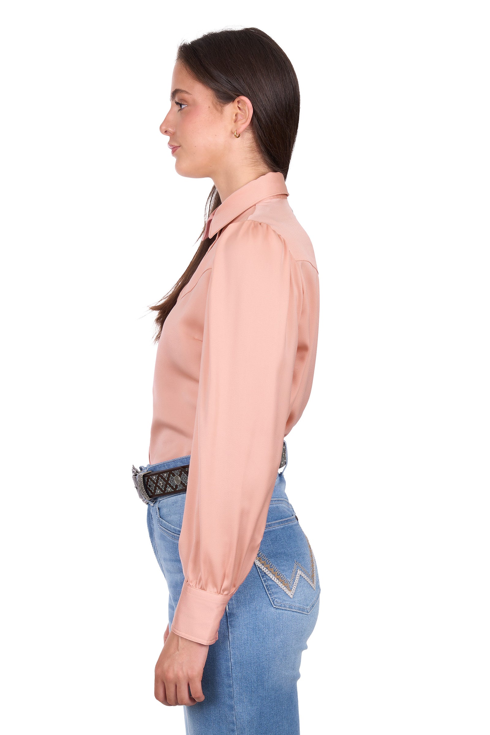 Woman wearing a light pink blouse and blue jeans on a white background