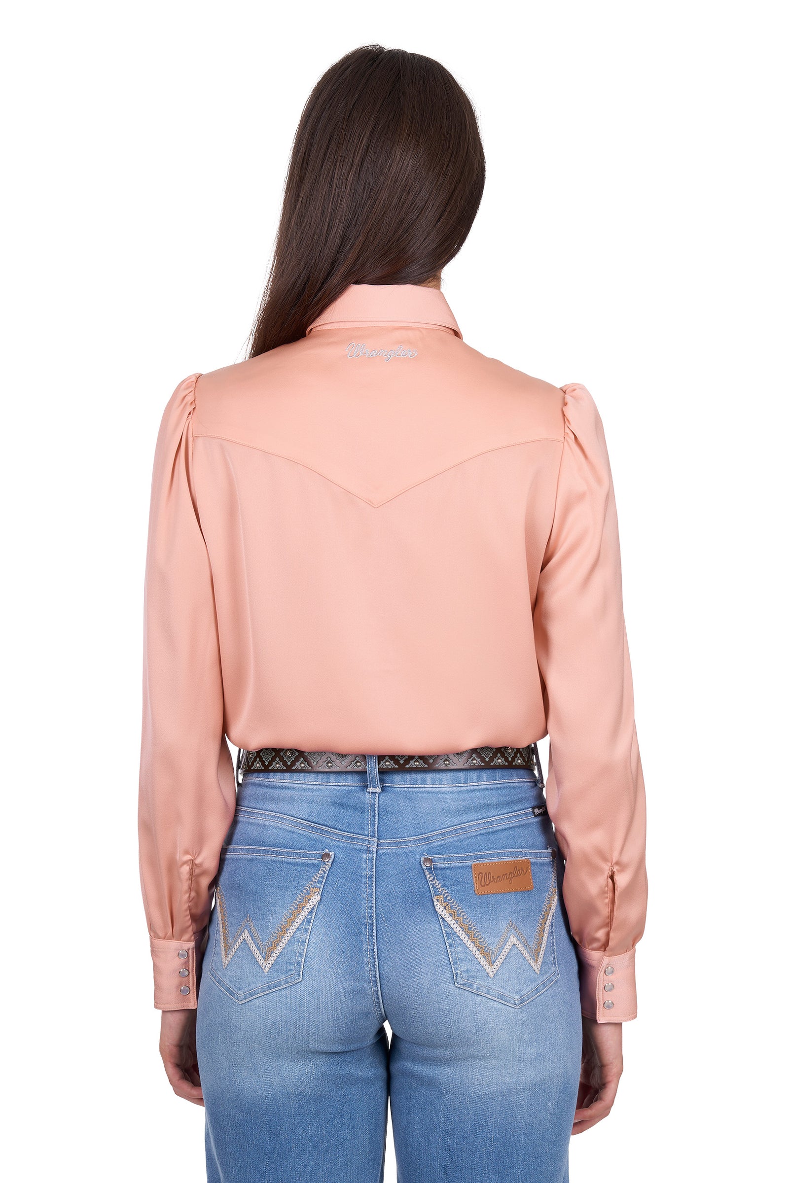 Person wearing a peach blouse and blue jeans on a white background