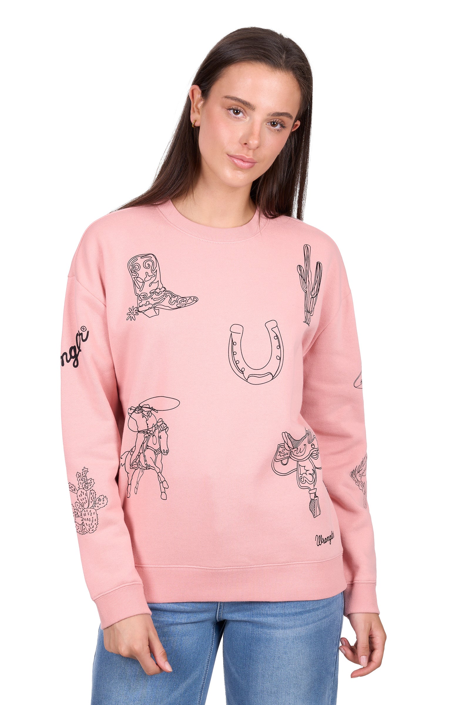 Woman wearing a pink sweatshirt with graphic designs on a white background