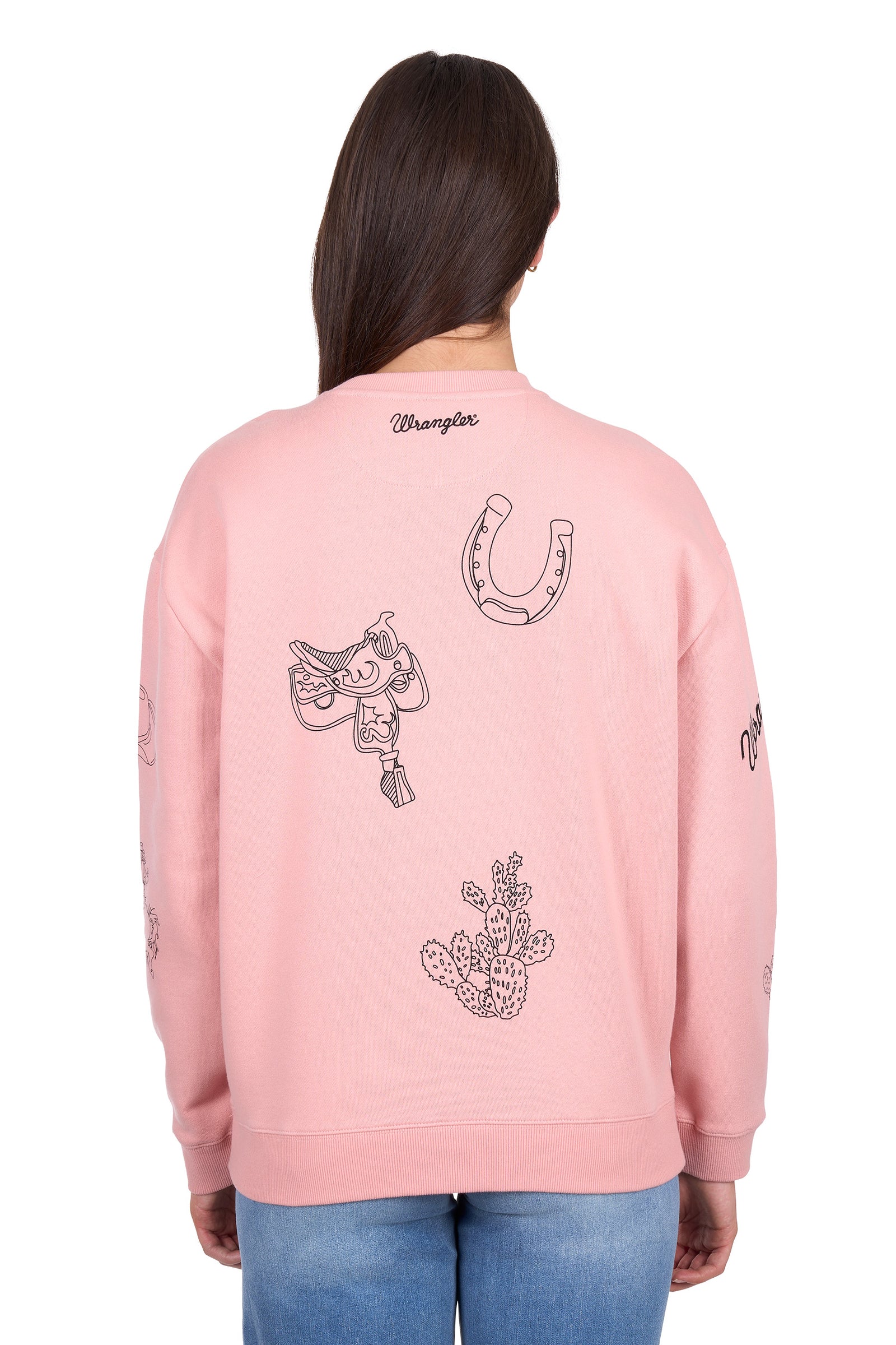 Woman wearing a pink sweatshirt with graphic designs on a white background