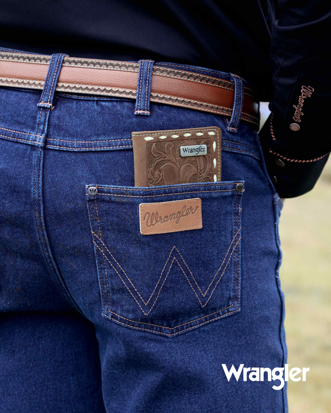 Close-up of blue jeans with Wrangler logo and branding.