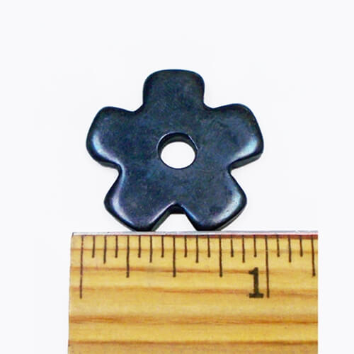 Barstow Bareback 5pt 1&quot; Rowels. A black bareback rowel placed on top of a wooden ruler for measurement.