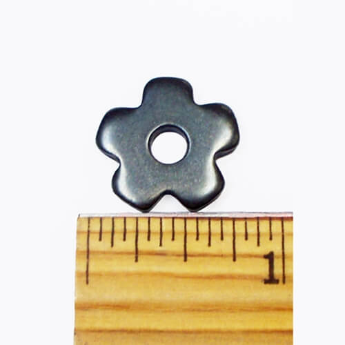 Barstow Saddle Bronc Rowels. A saddle bronc rowel placed on top of a wooden ruler, displaying its size.