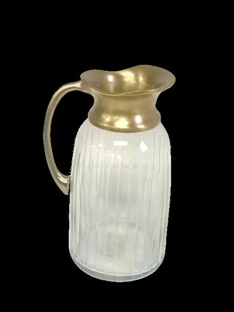 Clear glass pitcher with gold metallic top on a black background