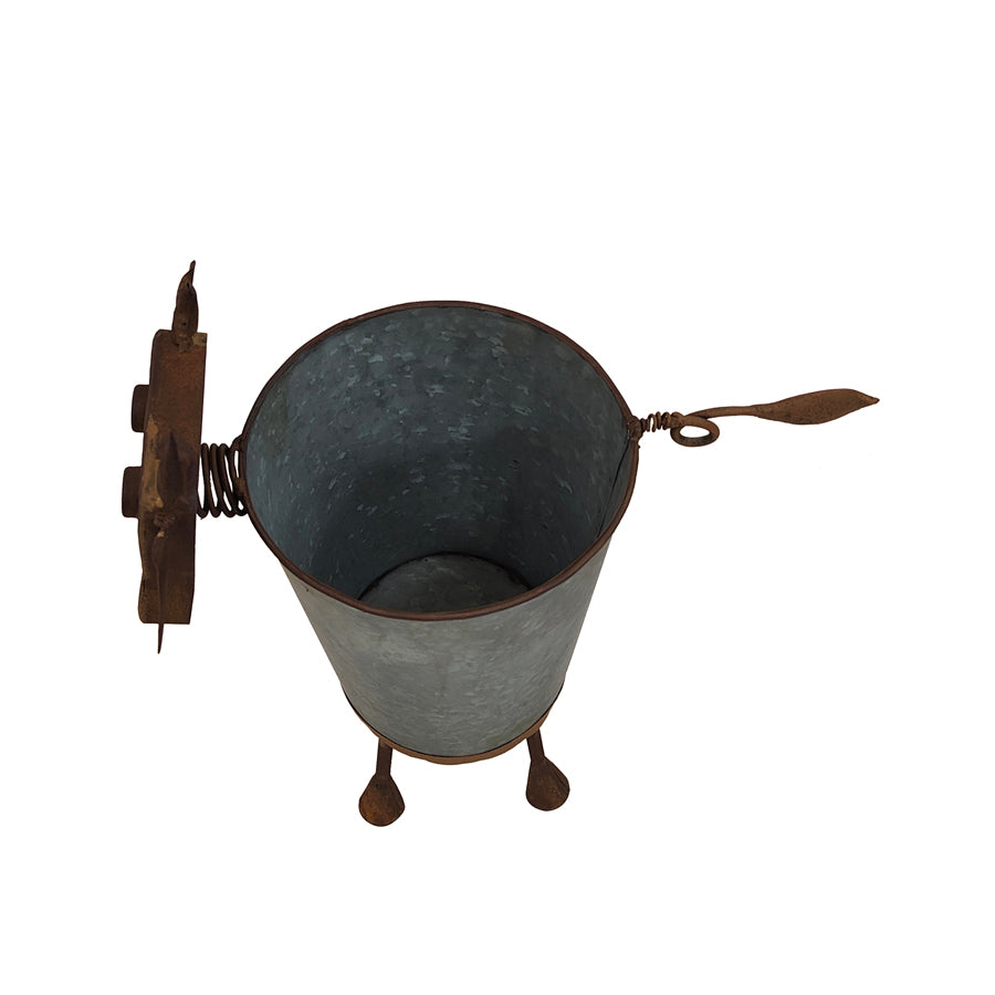 Rusty Cow Planter w/ Galv Pot. Metal bucket with rustic design on a white background
