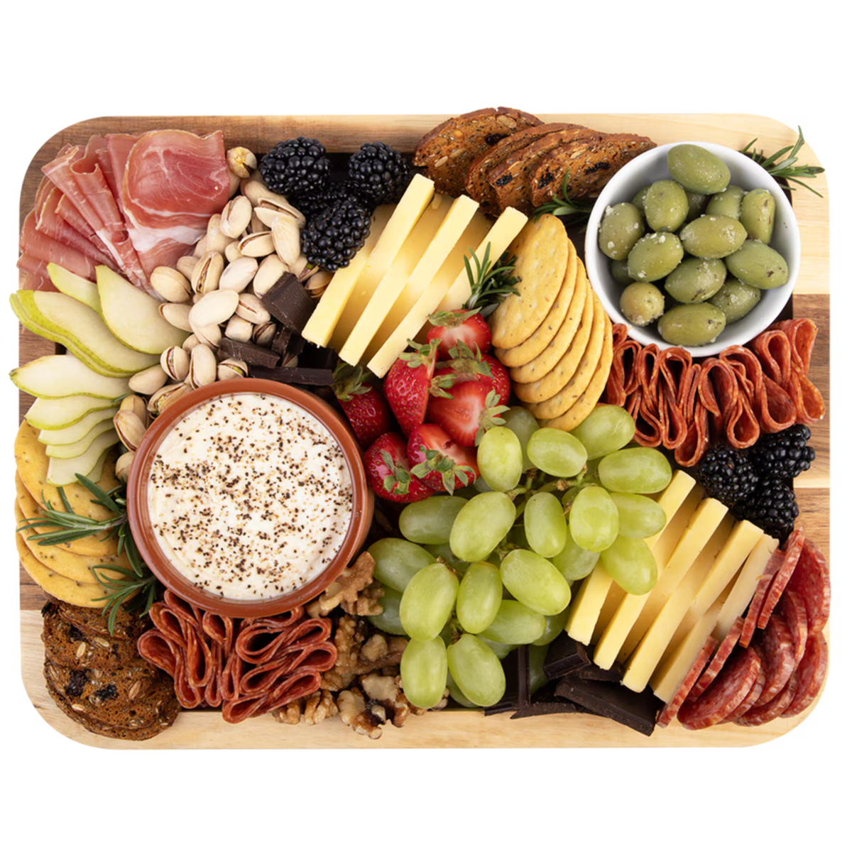 A beautifully arranged charcuterie board on a light wood tray, featuring cheeses, crackers, sliced meats, nuts, berries, grapes, and dips, isolated on a white background.
