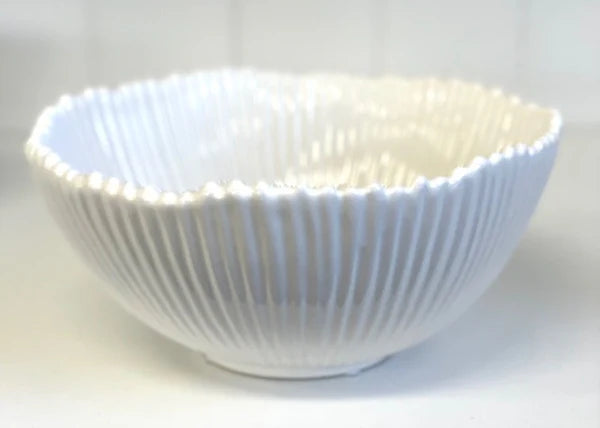 White Ribbed Ceramic Bowl. White ceramic bowl with ribbed texture on a white background