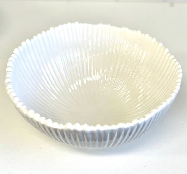 White Ribbed Ceramic Bowl. White ceramic bowl with textured interior on a white background