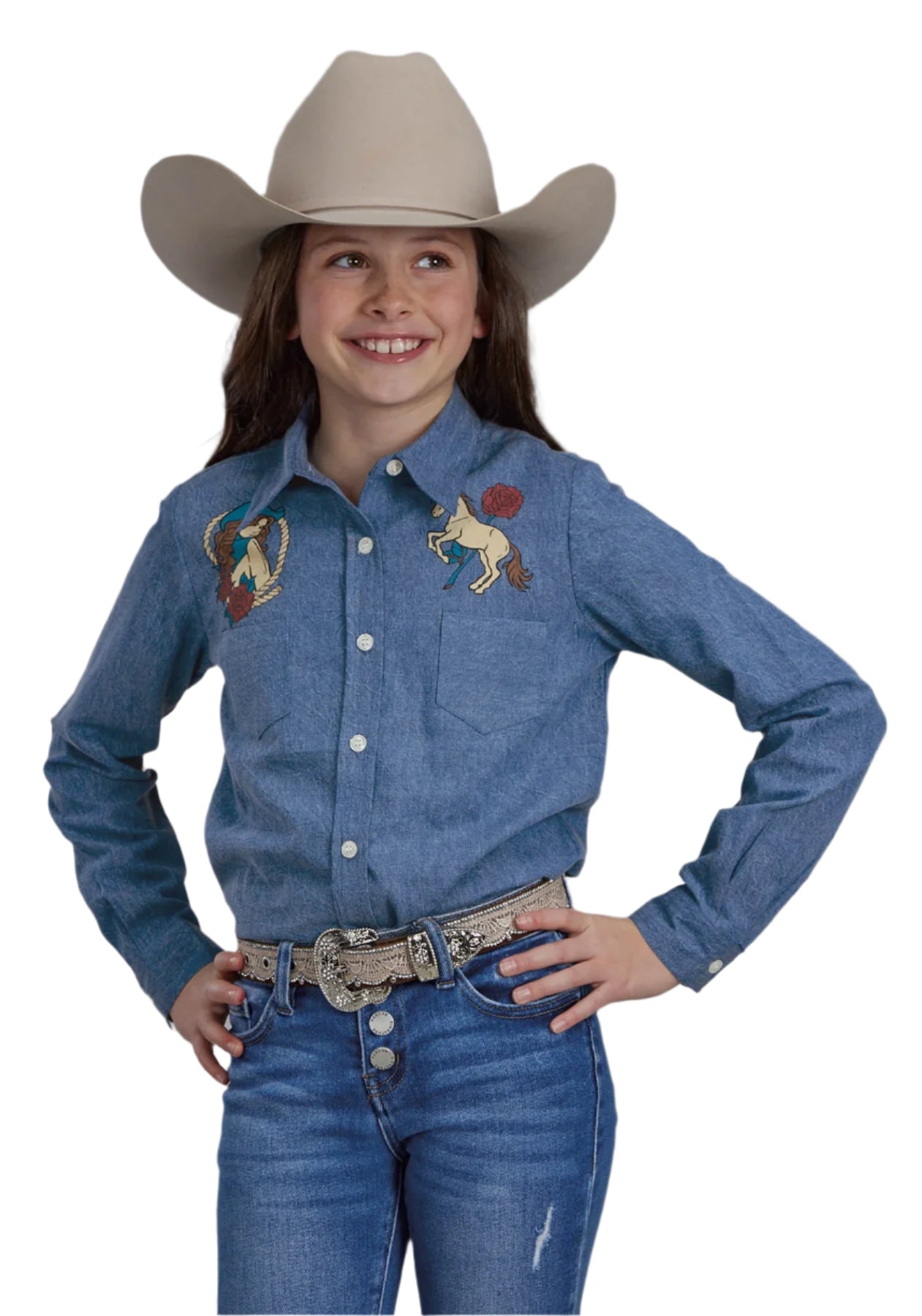 Roper Girl's Five Star Collection L/S Shirt. A girl wearing a long sleeve blue denim shirt with embroidery, buttoned all the way down the front, paired with blue jeans and a wide-brimmed hat.