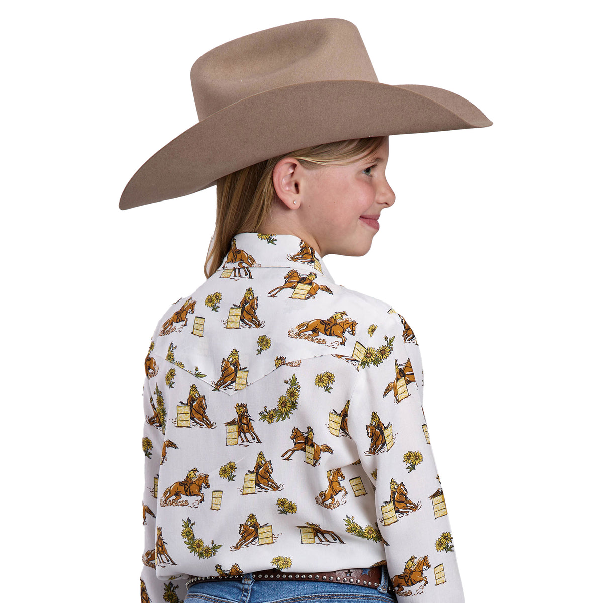 Child wearing a cowboy hat and patterned shirt on a white background