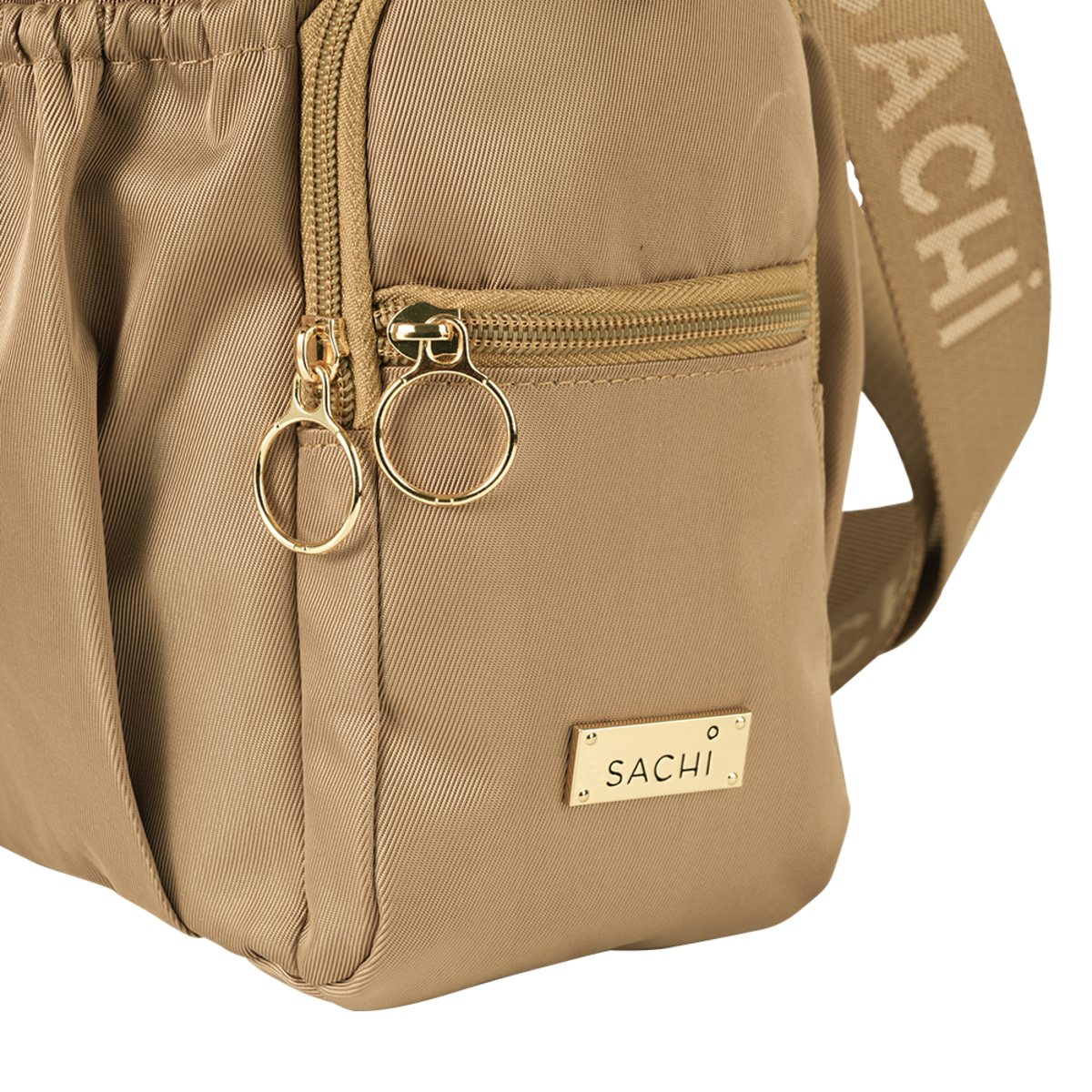 Sachi Crossbody Insulated Bottle Bag. Beige backpack with gold zipper and 'SACHI' branding on a white background