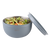 Oasis Stainless Steel 2.8 L Double Wall Salad Bowl with Lid. Gray salad bowl with a salad and a lid on a white background