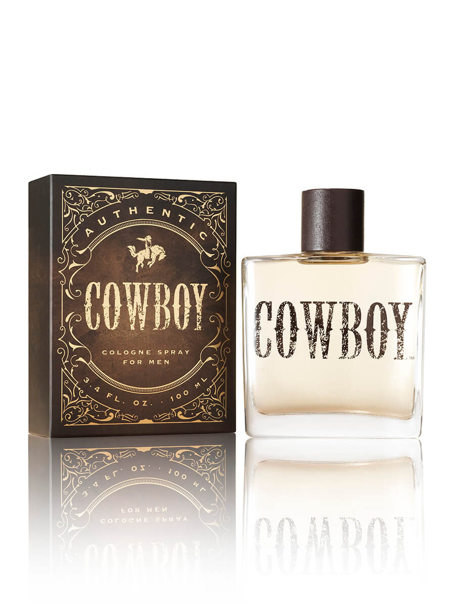 A bottle of Tru Western Men's Cowboy Cologne with packaging. The bottle is clear with a brown liquid inside and has 'COWBOY' written on it.