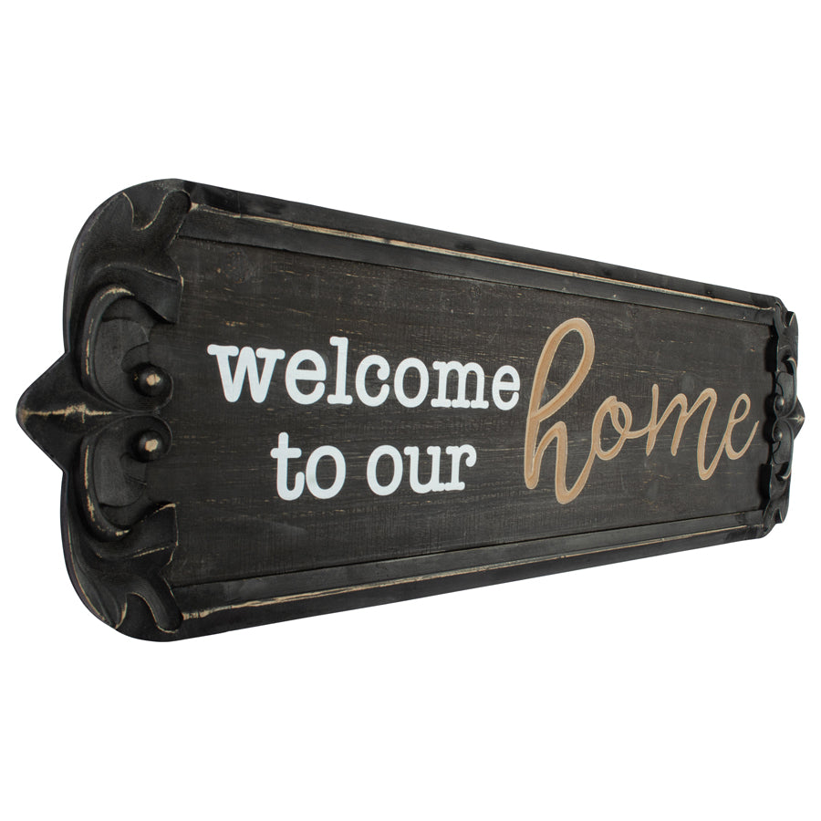 80cm Nero ‘Welcome to Our Home’ Carved Wall Art. Decorative sign with 'welcome to our home' text on a white background