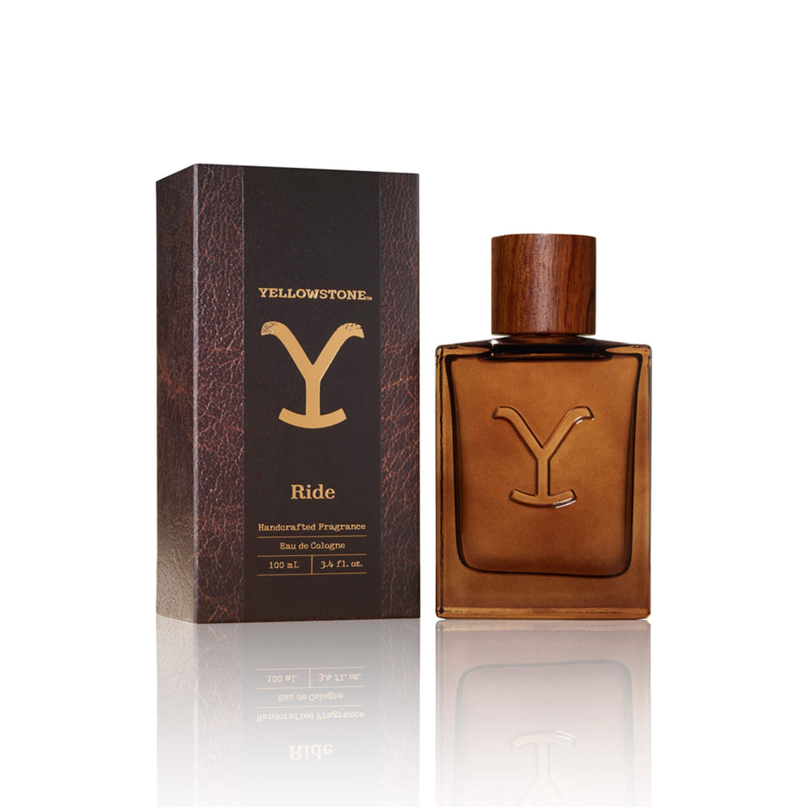 Tru Western Men's Yellowstone Ride. A cologne bottle and box with a 'Y' logo, indicating the 'Yellowstone Ride' by Tru Western. The bottle is brown, and the box is brown and beige with a 'Y' logo.
