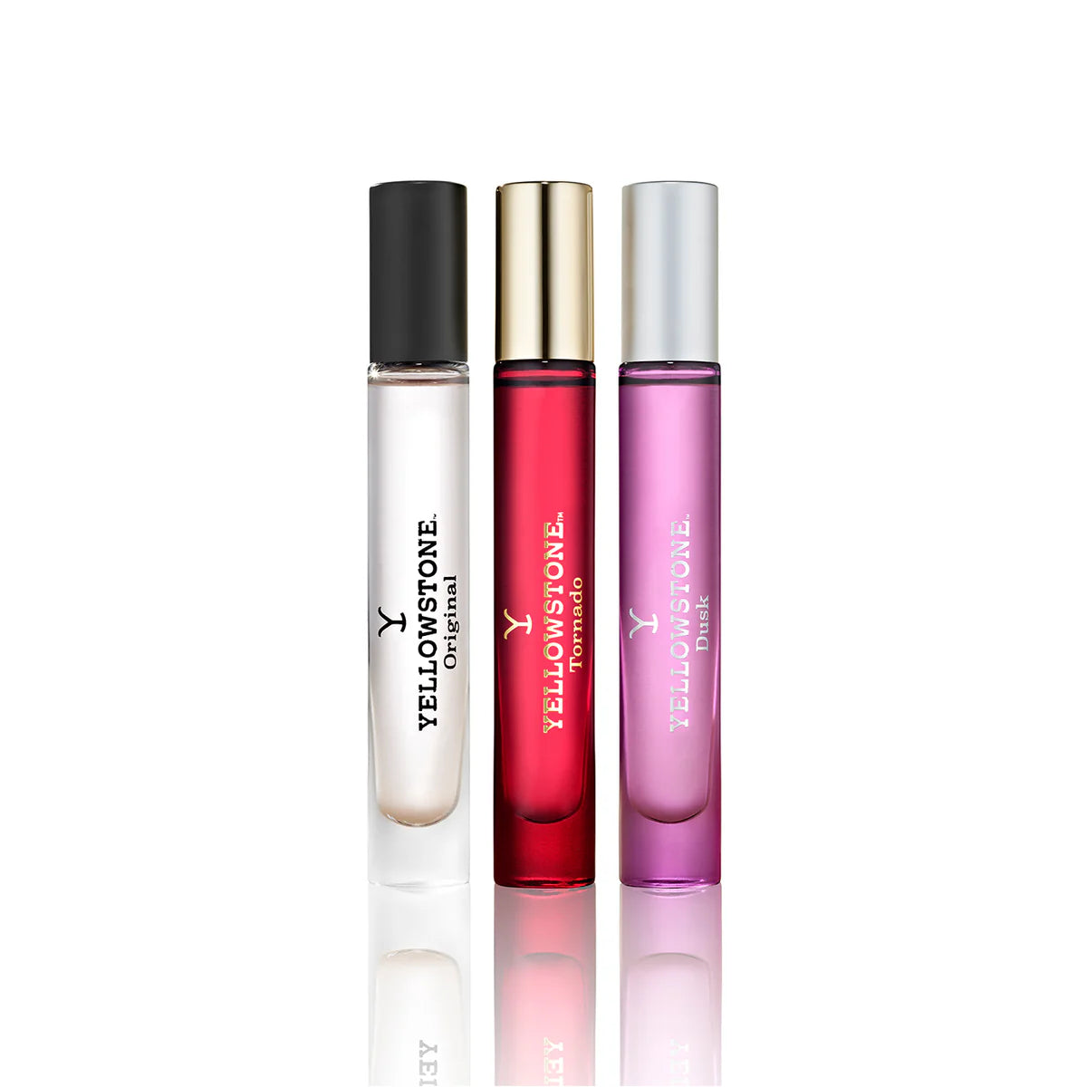 Three Yellowstone perfume bottles in black, gold, and pink on a white background