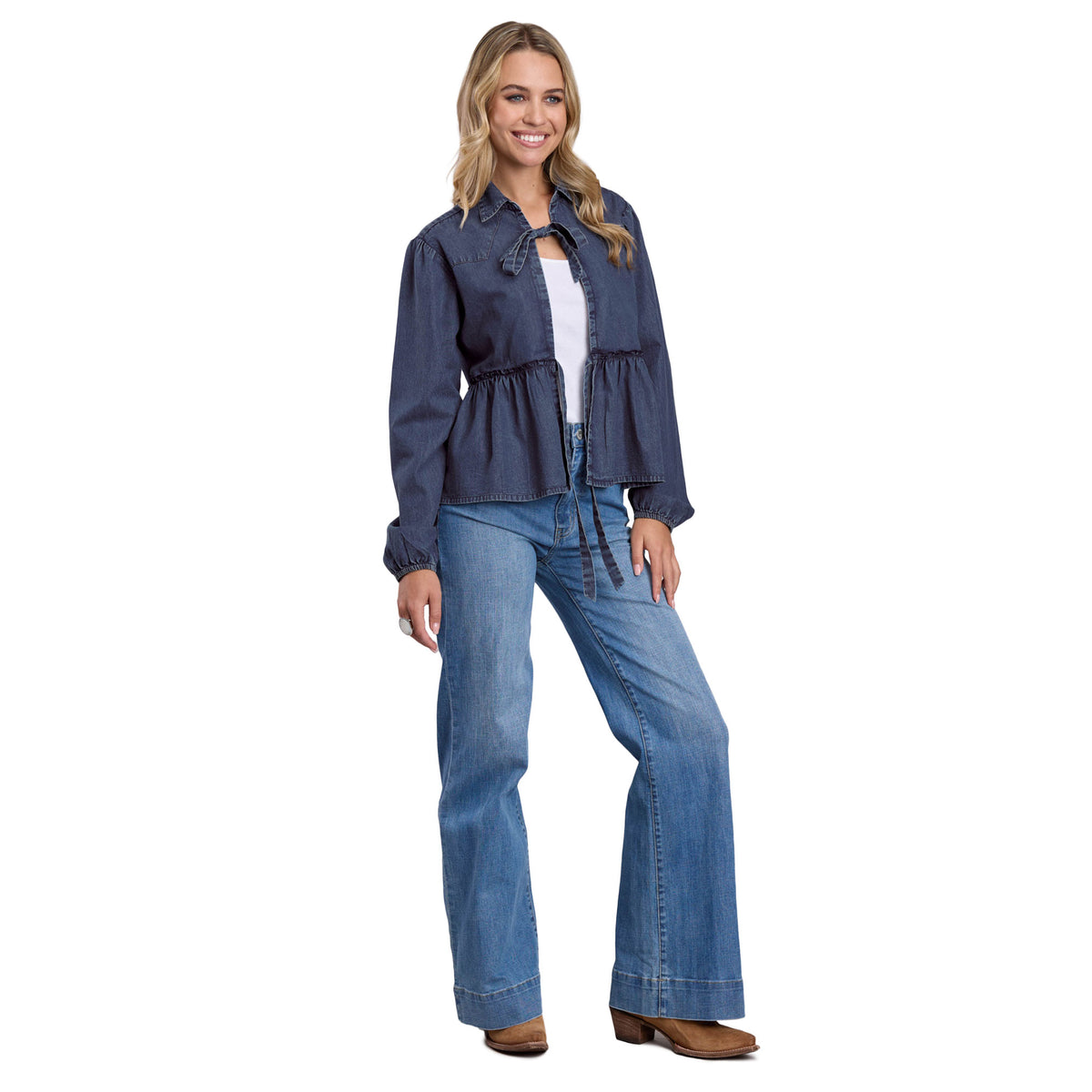 Woman wearing a denim jacket and jeans on a white background
