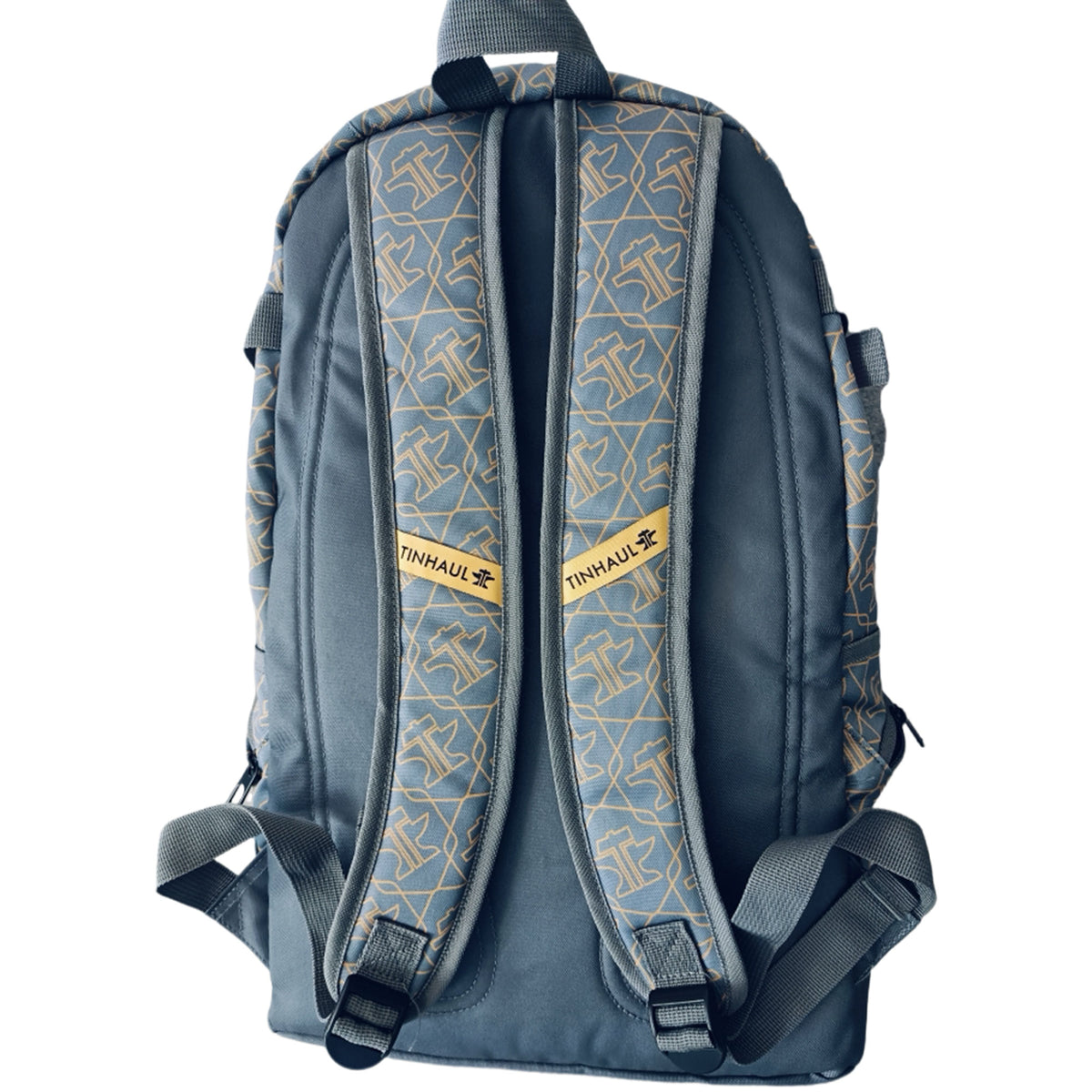 Tin Haul Backpack. Backpack with brand logo on straps against a white background