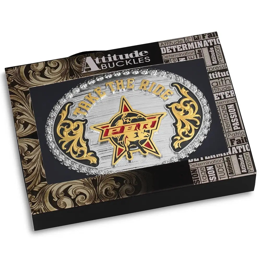 Belt buckle with 'Take the Ride' and 'Toro' design on a decorative box, featuring Attitude Buckles branding.