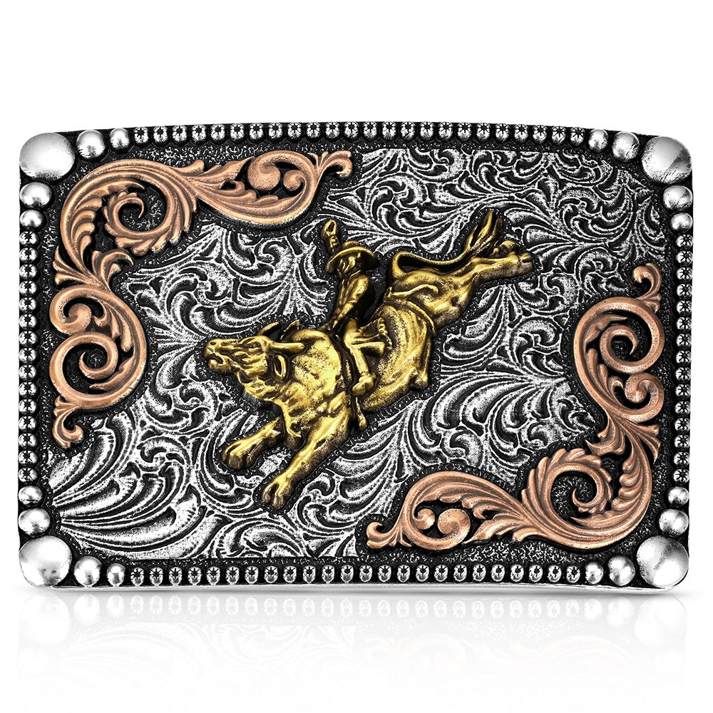 A rectangular western-style belt buckle featuring a highly detailed relief design of a cowboy riding a bucking bull. The buckle has a textured silver background with engraved scrollwork, rose gold scroll accents in the corners, and a polished gold bull and rider in the center, all framed by a silver beaded border.